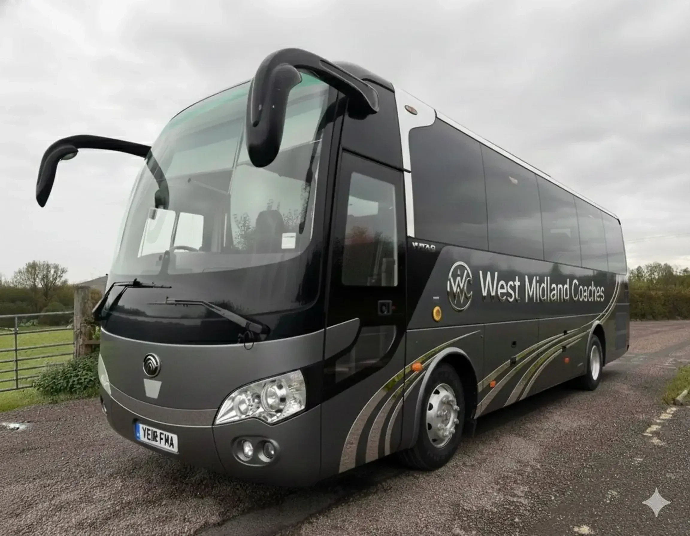 WMC coach in West Midland Coaches livery, photographed from the front three-quarter view