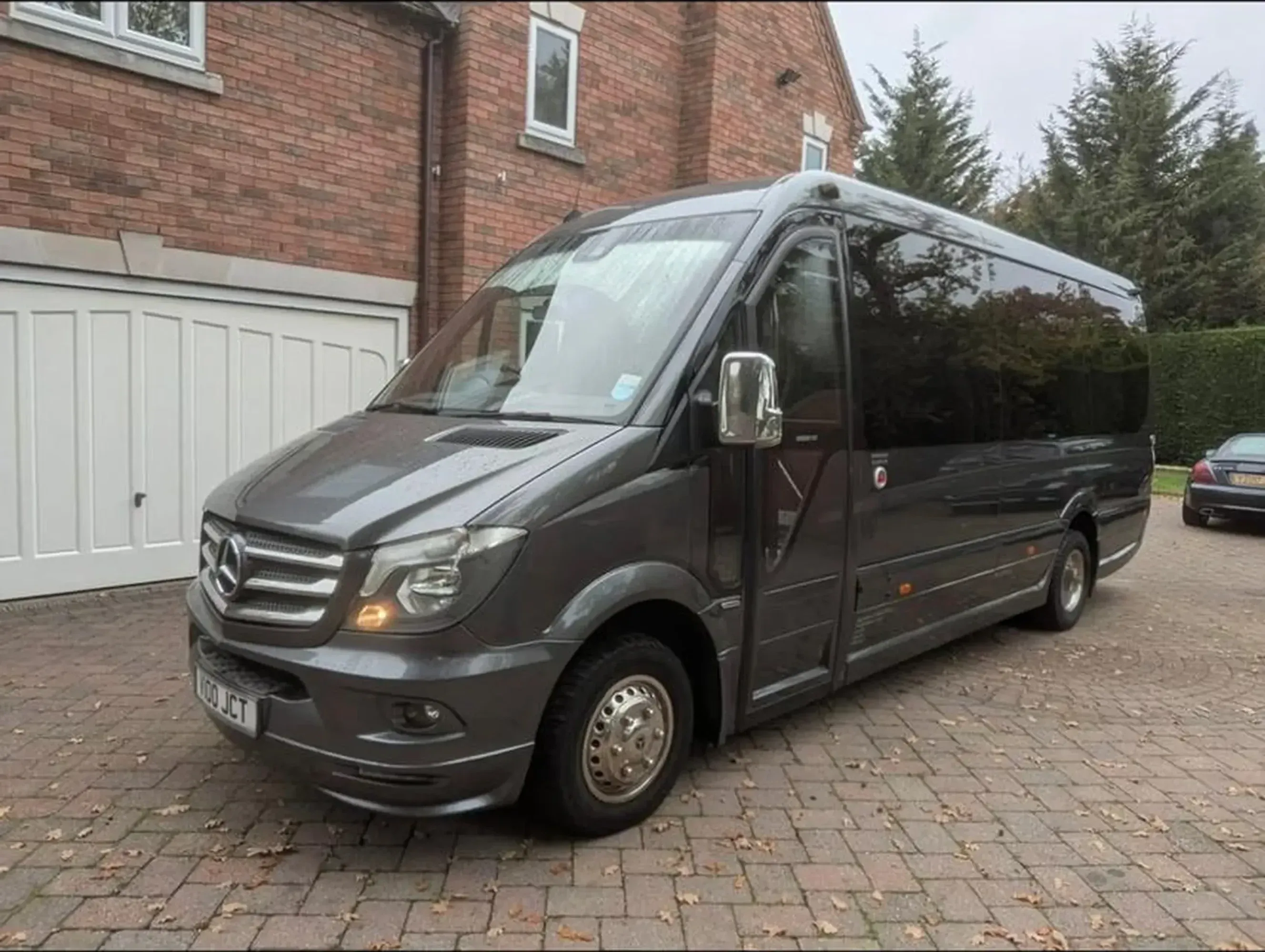 WMC minibus photographed from the front three-quarter view outside a residential property