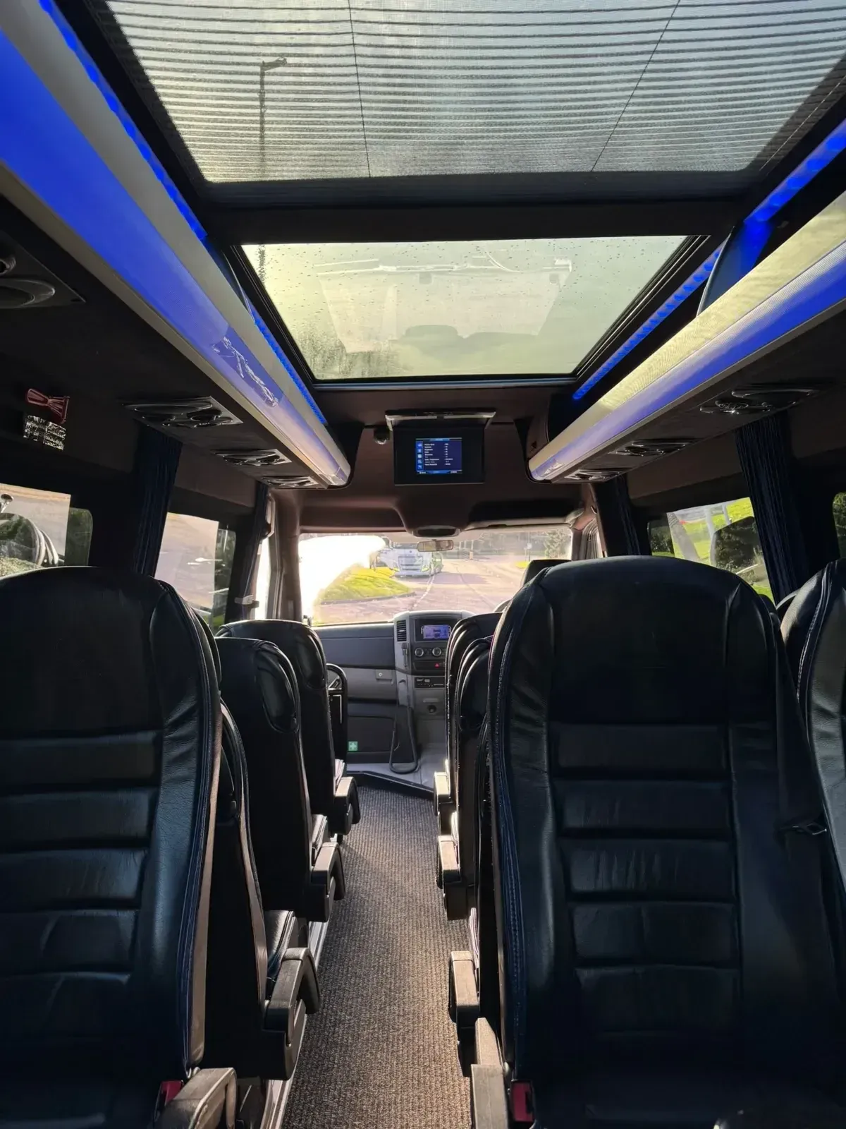 Interior seating view toward the front of a supplied WMC minibus