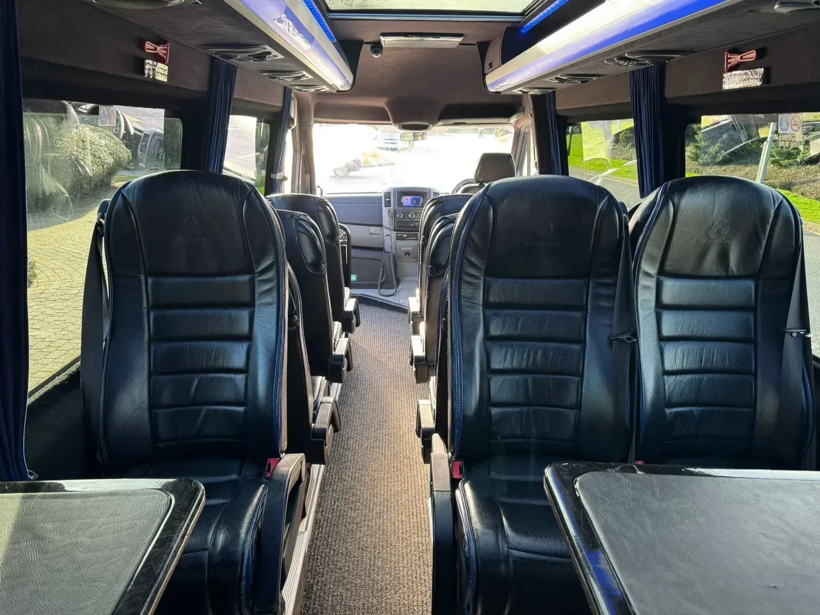 Interior seating view with fold-out tables from supplied WMC minibus photography
