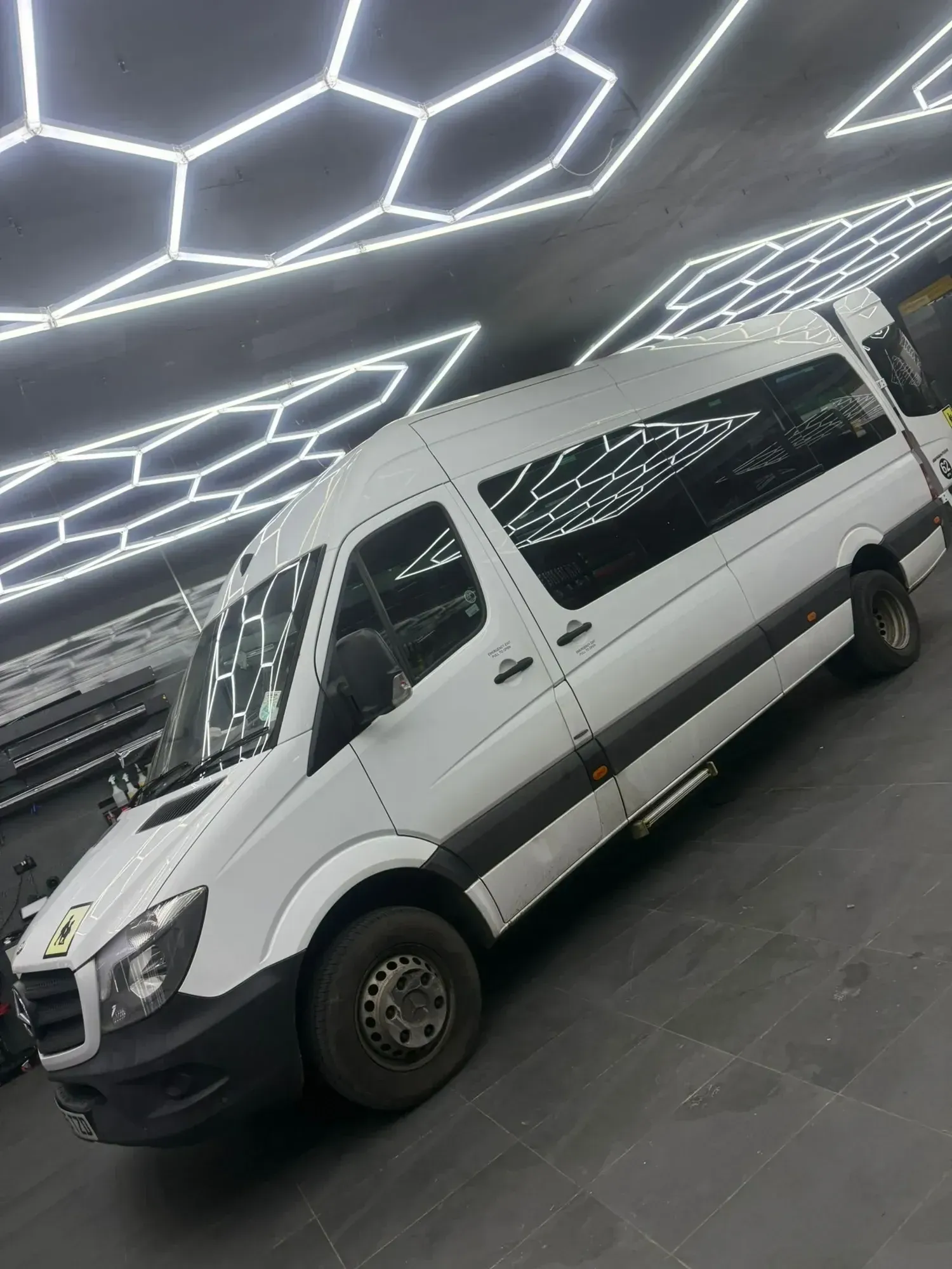 WMC minibus photographed from the front three-quarter view indoors